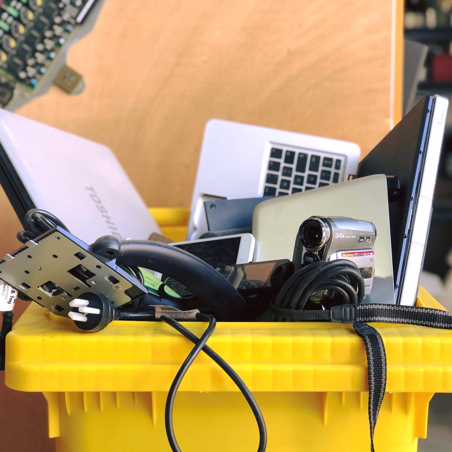 electronic waste in a yellow bin