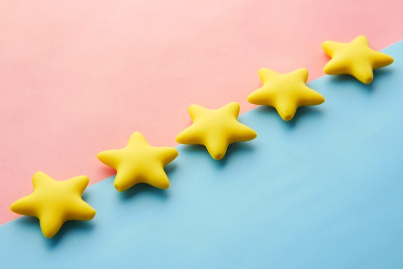 five yellow stars with pink and blue background